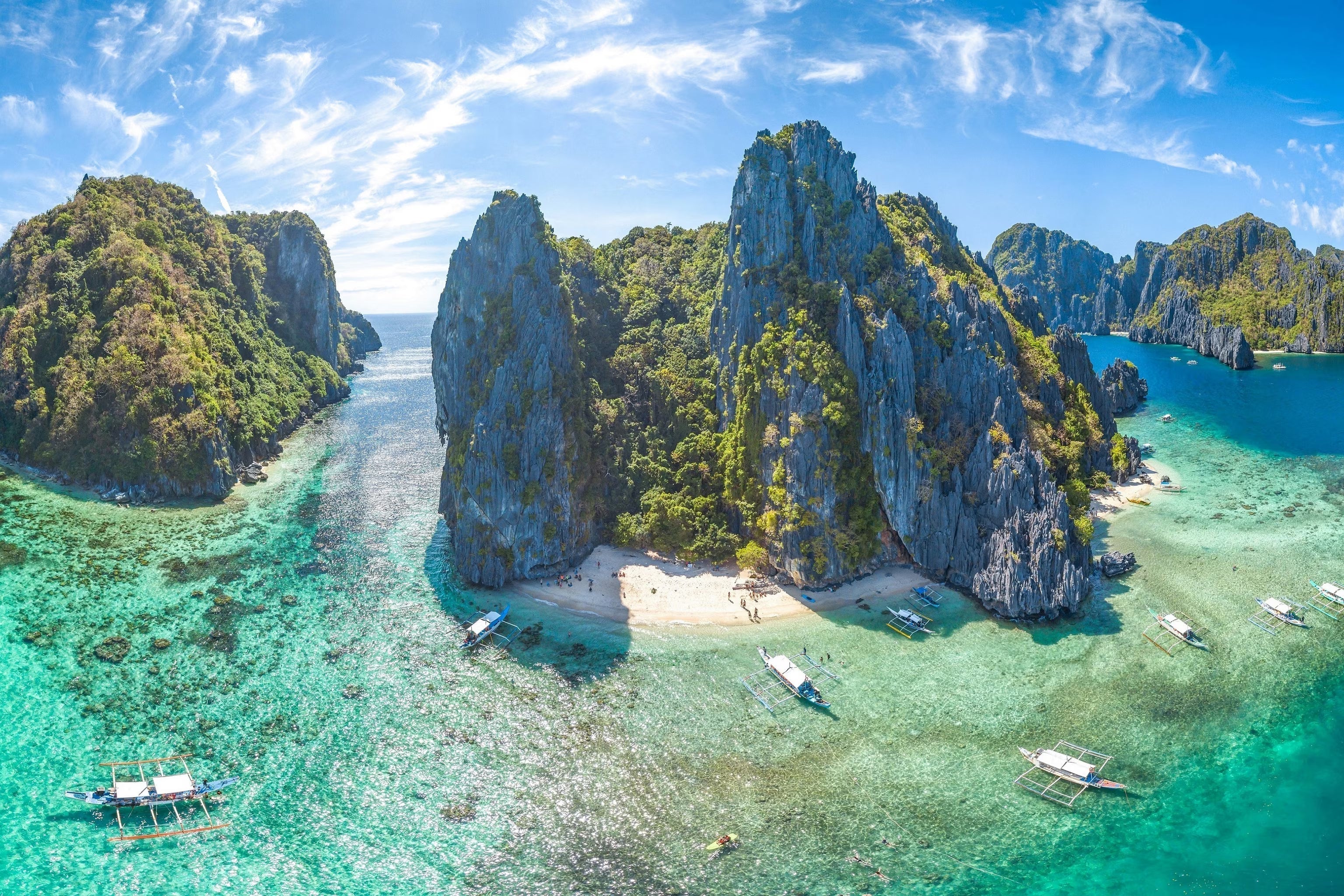 Wide aerial view of colorful tropical island surrounded by crystal blue ocean | Altitude Philippines