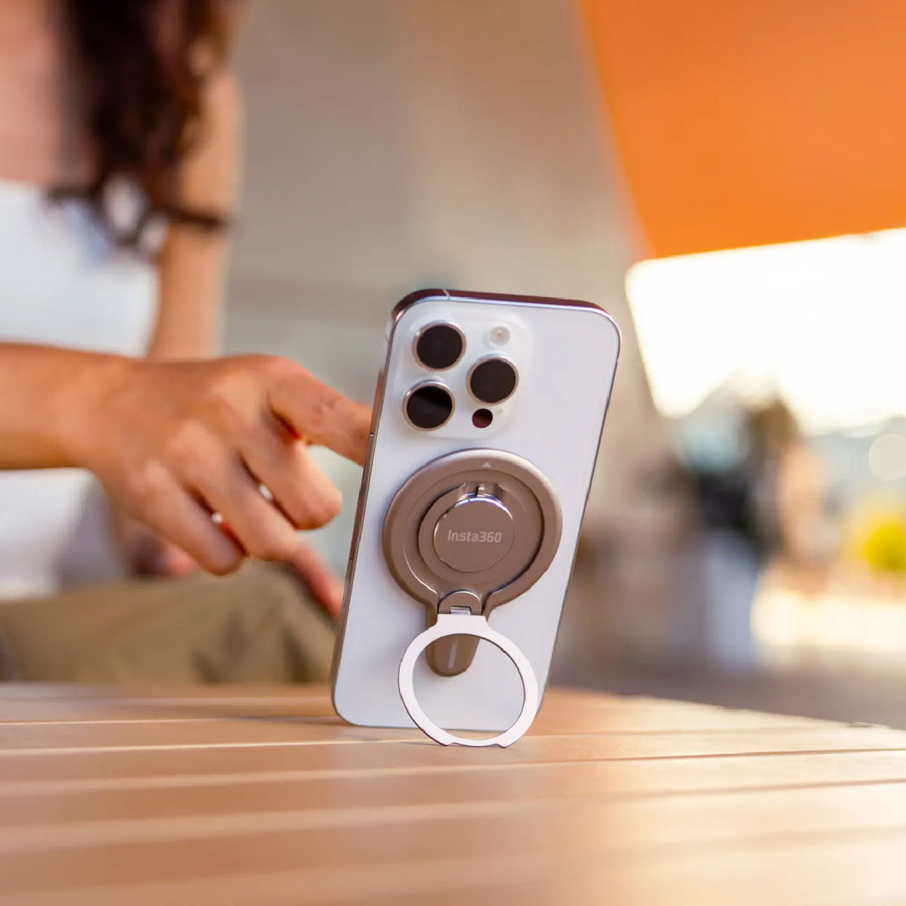 Girl using the Insta360 Flow 2 Pro mount as a phone stand