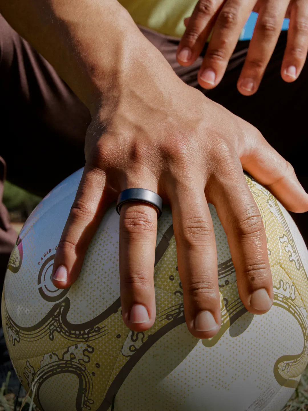 Man wearing a smart ring while holding a ball during an active lifestyle scene | Altitude Philippines