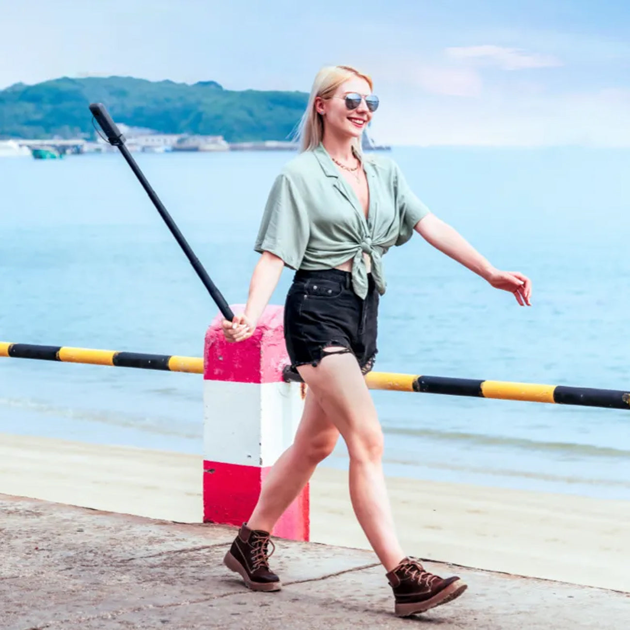 Girl taking selfie using the Insta360 Power Selfie Stick