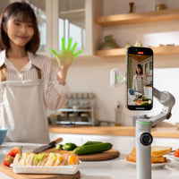 Woman in the kitchen recording a video using the Insta360 Flow 2 Pro Gimbal