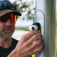 Man attaching the Insta360 Go 3 to a metal pole using the Pocket Flexi Mount