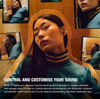 Woman listening to music using the Marshall Minor IV True Wireless Earbuds