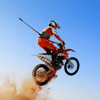 Guy on dirt bike wearing Insta360 Enhanced Waist Strap for hands-free action footage
