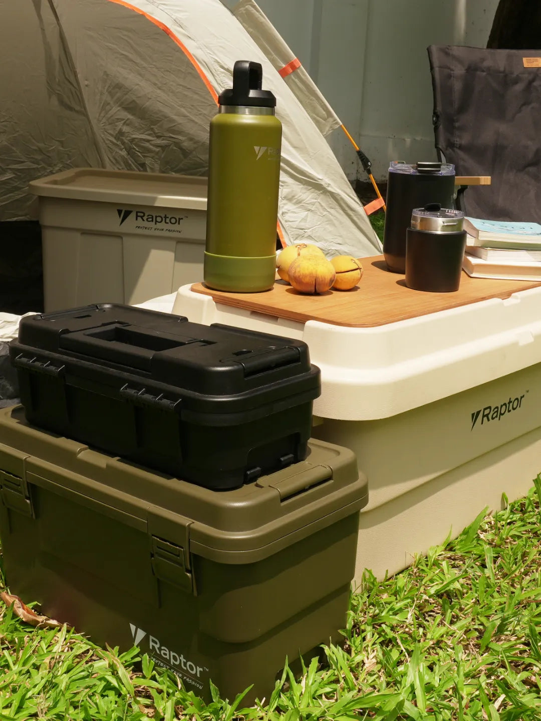 Camping setup in an open field with hard cases, cooler, tumblers and mugs | Altitude Philippines