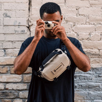 Guy using Wandrd Rogue Sling 3L Bag