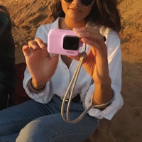 Girl using the Sleeve and lanyard in pink on hr GoPro