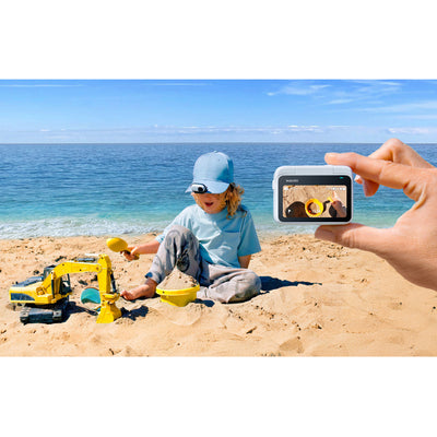 Kid using the Insta360 Go 3S Action Camera to record his POV playing in the sand