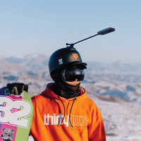 Guy snow boarding using the Insta360 Unicorn Helmet Mount