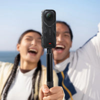 Couple taking a selfie using their Insta360 X5 with Thermo Grip Cover