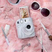 Flat lay of Instax Mini 12 Clay White