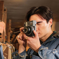 Guy using the Instax Mini 41