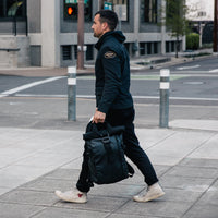 Guy holding Wandrd PRVKE 21 Backpack