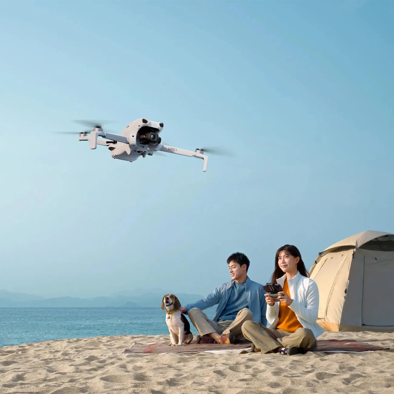 Couple with their dog relaxing at the beach while flying a drone | Altitude Philippines