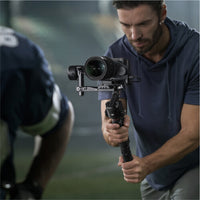 Photographer using DJI RS 4 Gimbal Stabilizer to capture stunning photos and videos for sports