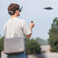 Person using the STARTRC Carrybag on his shoulder while flying a drone