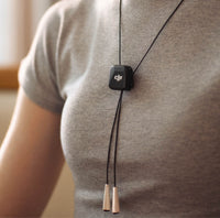 DJI Mic Mini Transmitter around a person's neck