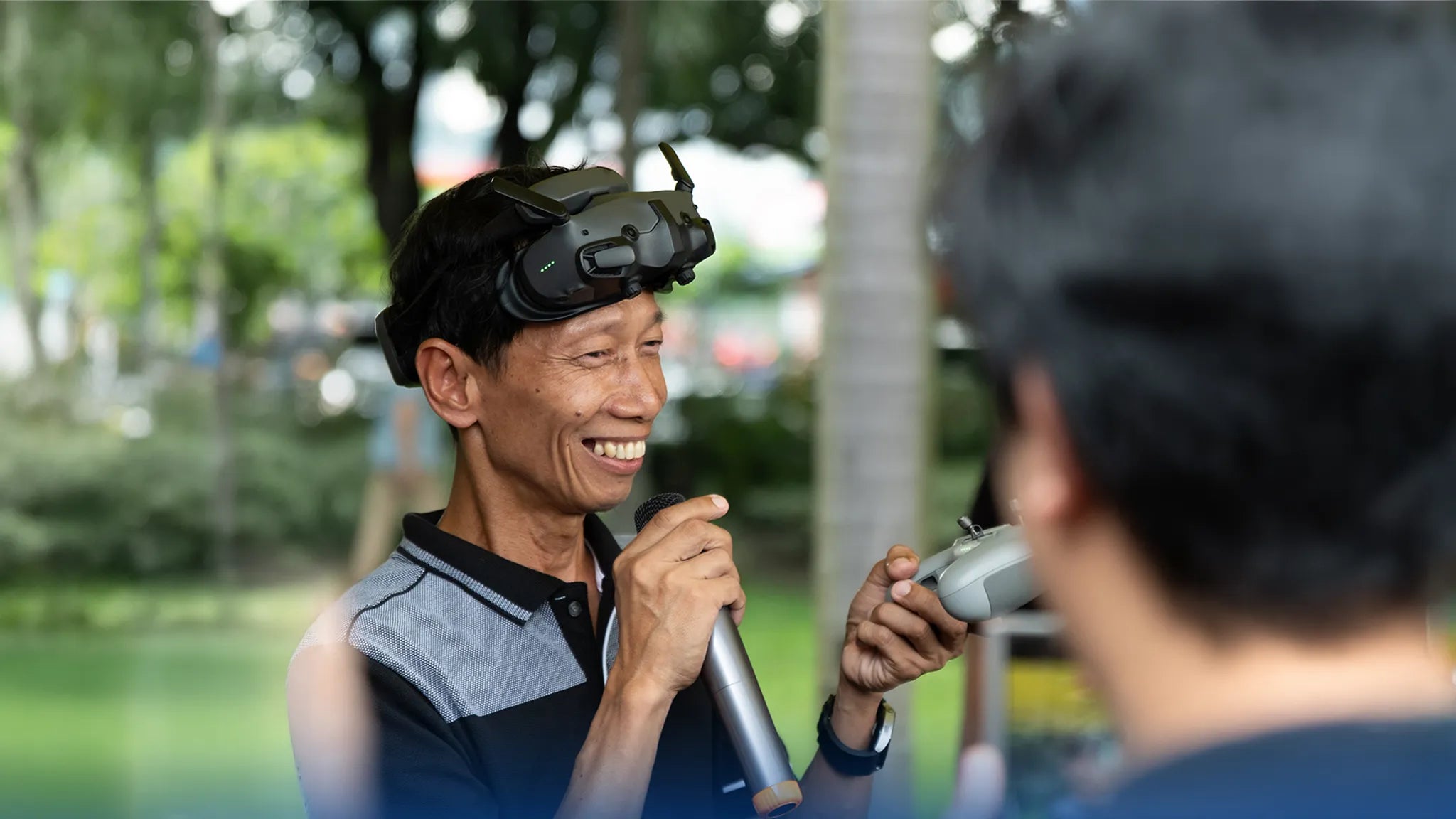 Man wearing a VR headset while speaking into a microphone outdoors | Altitude Philippines