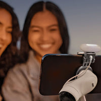 Girls taking a selfie with Insta360 Flow Pro Spotlight attached to phone